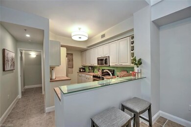 Kitchen featuring kitchen peninsula, tasteful back