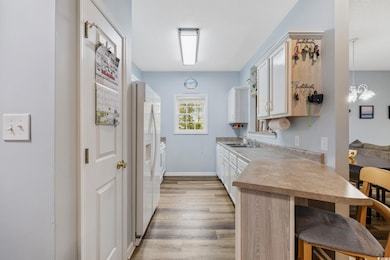 Kitchen featuring an inviting chandelier, light co