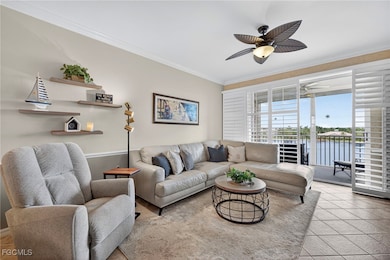 Living room featuring light tile patterned floors, ornamental molding, and a water view
