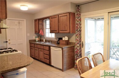Kitchen showing access door from carport and slidi