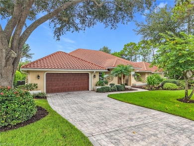 Mediterranean / spanish home featuring stucco siding, an attached garage, a front yard, decorative driveway, and a tiled roof