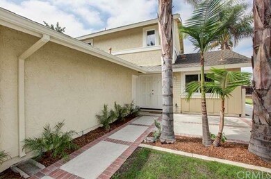 Brick lined walk way leads to front patio area and