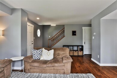 Another view of the living room with staircase to 