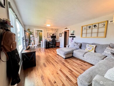 Walnut engineered hardwood floors throughout. Spacious living room with room for a dining table or a desk.