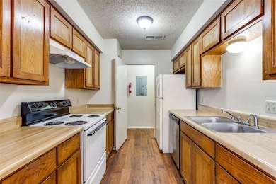 Kitchen with electric panel, a sink, range with el