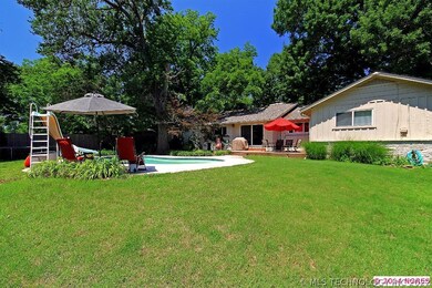 The pretty backyard has a pool and plenty of grass
