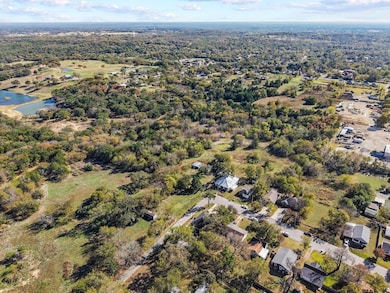 Aerial view of property and surrounding area featuring a large body of water