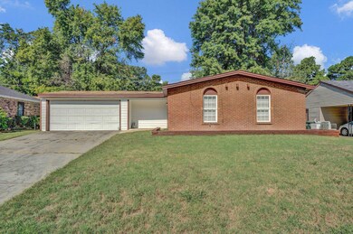 View of front facade with a garage and a front yar