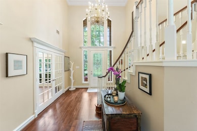 This elegant foyer features high ceilings, a grand