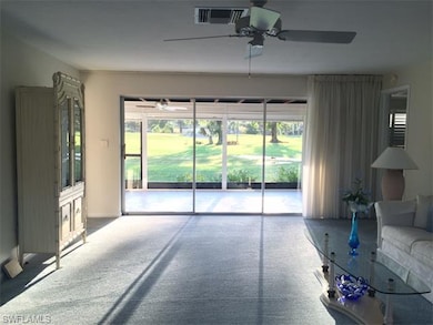 Living Room with Sliding Glass Doors to LanaiGolf 