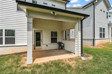 Back of property featuring a patio and a yard
