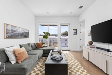 Living room featuring visible vents and wood fini