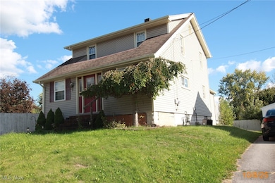 View of front of home with roof with shingles and a chimney