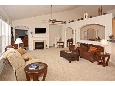 Living Room. Check out the fireplace & the custom look the arches and columns provide!!