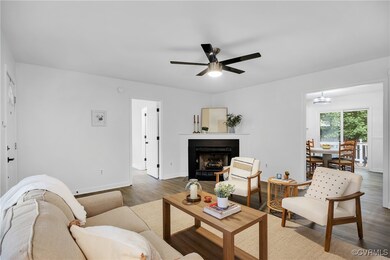Living area with wood finished floors, a fireplace