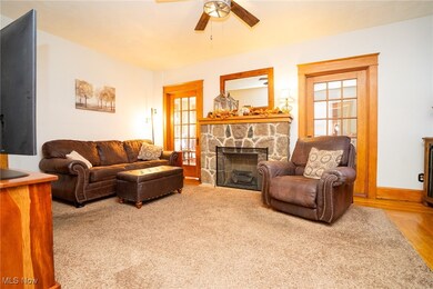 Living room with a fireplace and ceiling fan
