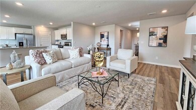 Living room featuring recessed lighting, wood finished floors, and a textured ceiling