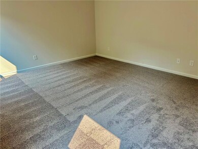 Carpeted spare room with baseboards