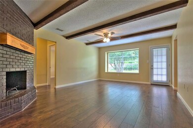 Living Room with wood burning Fireplace.  Door on
