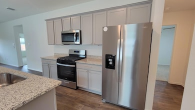 Kitchen featuring stainless steel appliances, gra