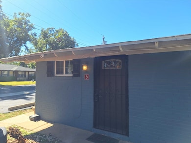 Entrance to property featuring brick siding