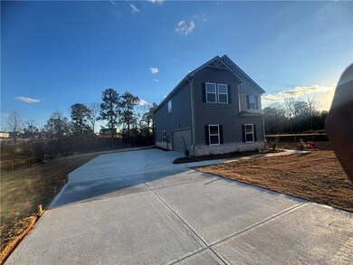 View of side of home featuring a garage