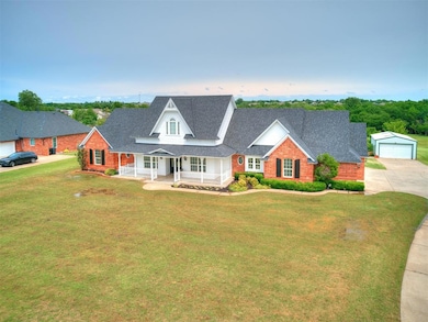 Cape cod house featuring a garage, a front lawn, a