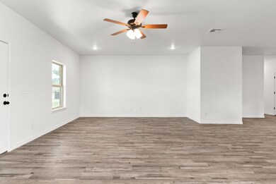 Empty room with baseboards, wood finished floors,