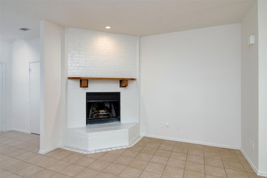 Unfurnished living room featuring baseboards, a fi