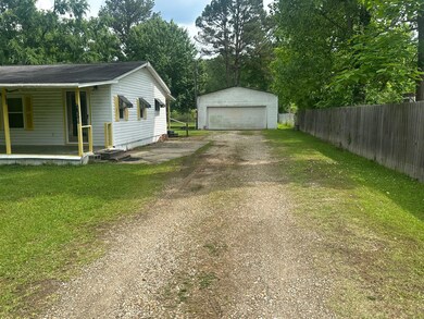 View of home's exterior featuring a porch, an outb