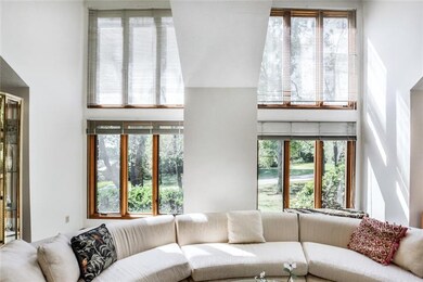 Enjoy beautiful views of the wooded front yard thr
