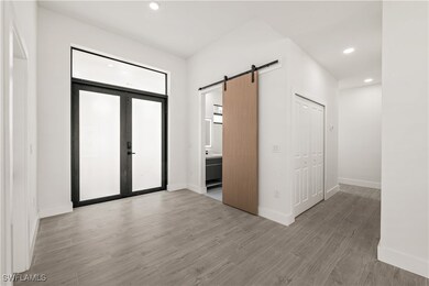 Entrance foyer featuring a barn door, light wood-s