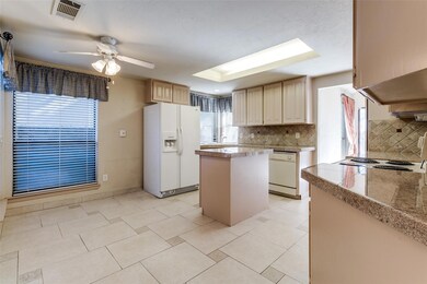 Kitchen featuring backsplash, white appliances, ce