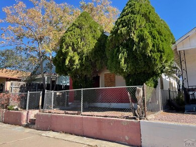 Front yard, fenced and trees