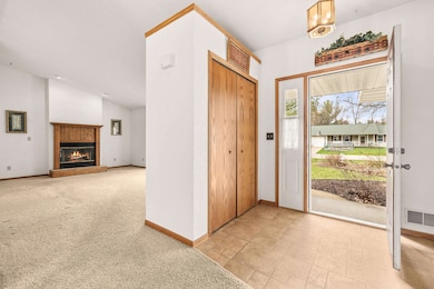 Tiled foyer with coat closet