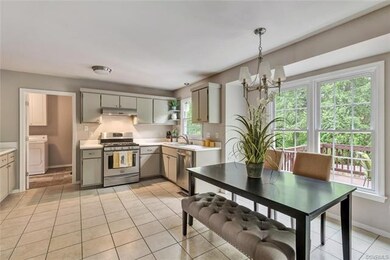 Large kitchen with stainless steel appliances, eat