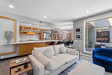 Living room with visible vents, an inviting chand
