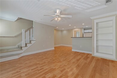 Unfurnished living room with baseboards, light woo
