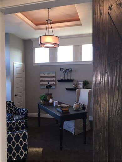 Office/den accented with sliding barn door