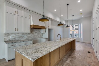 Kitchen featuring white cabinets, a spacious islan