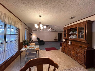 Dining room with a textured ceiling, crown molding