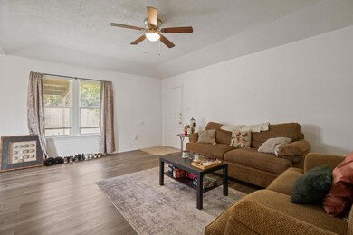 Living room featuring ceiling fan, wood finished 