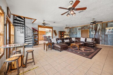 Living room featuring visible vents, a ceiling fa