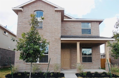 View of front of home featuring brick siding and 