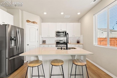 KITCHEN WITH LARGE QUARTZ ISLAND & GAS OVEN