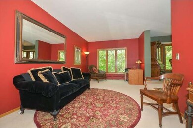 Formal Living Room overlooks the wooded backyard