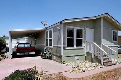 Back of carport and sunny patio area.