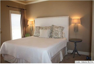 Nice-sized master suite with two windows and a wal