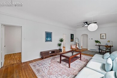Living area featuring wood-type flooring, baseboar