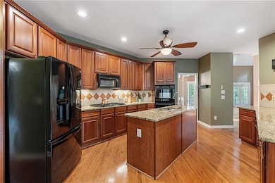 Main level kitchen features granite, island, breakfast bar, additional dining area, and great ambient lighting.